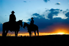 on horseback at sunset