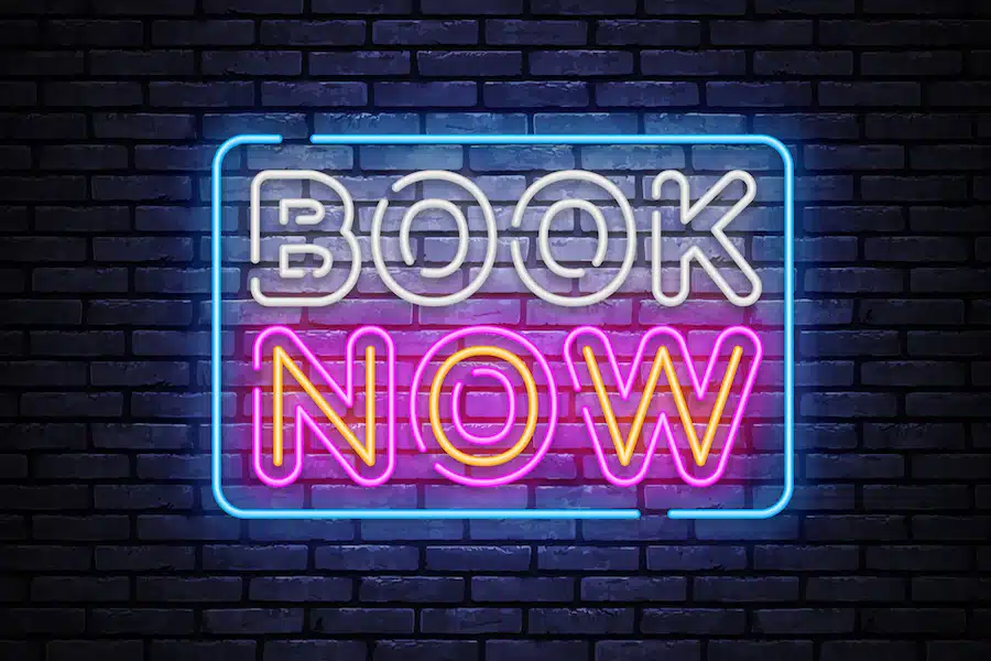 Book now neon for concept design. Blue book now neon sign. Vector background.