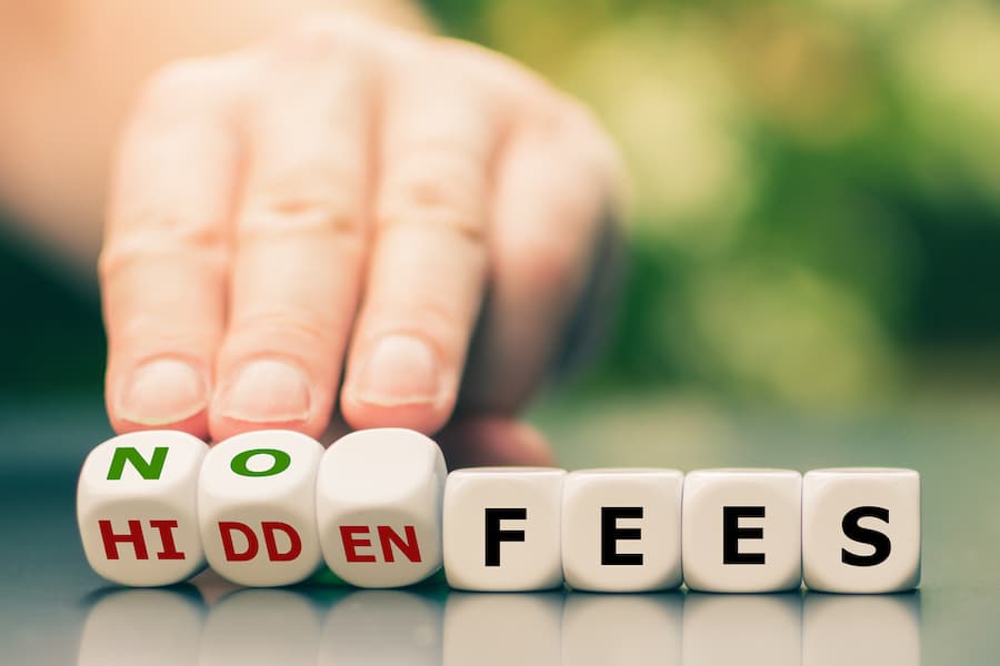 No hidden fees concept. Hand turns dice and changes the expression "hidden fees" to "no fees".