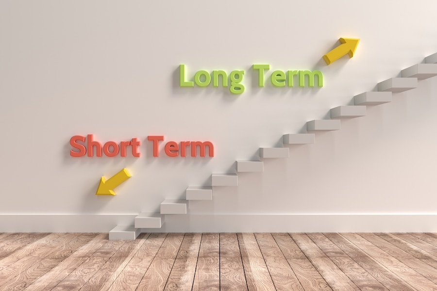 Decision making: stairs with "short term" pointing down and "long term" pointing up