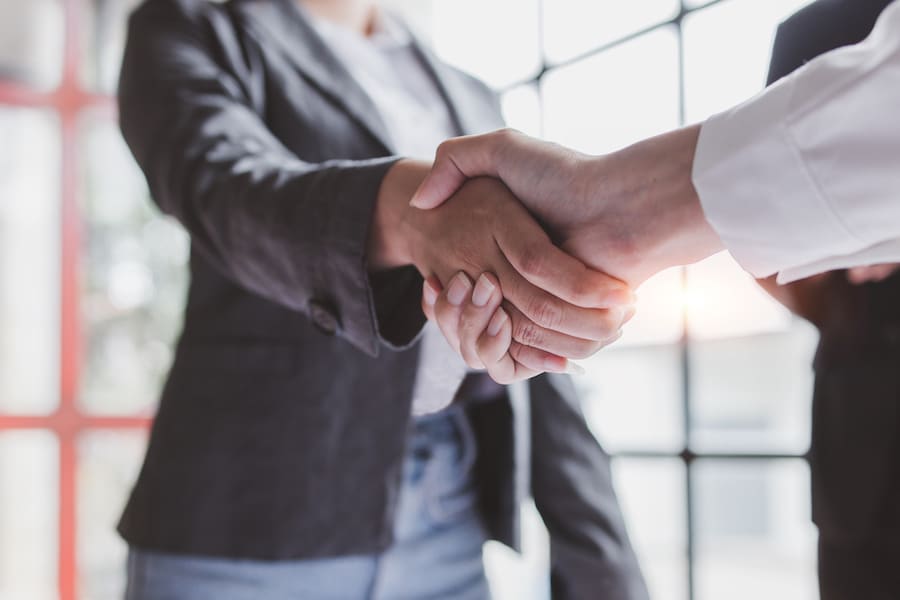 Business handshake for teamwork of business merger and acquisition,successful negotiate,hand shake,two businessman shake hand with partner to celebration partnership and business deal concept