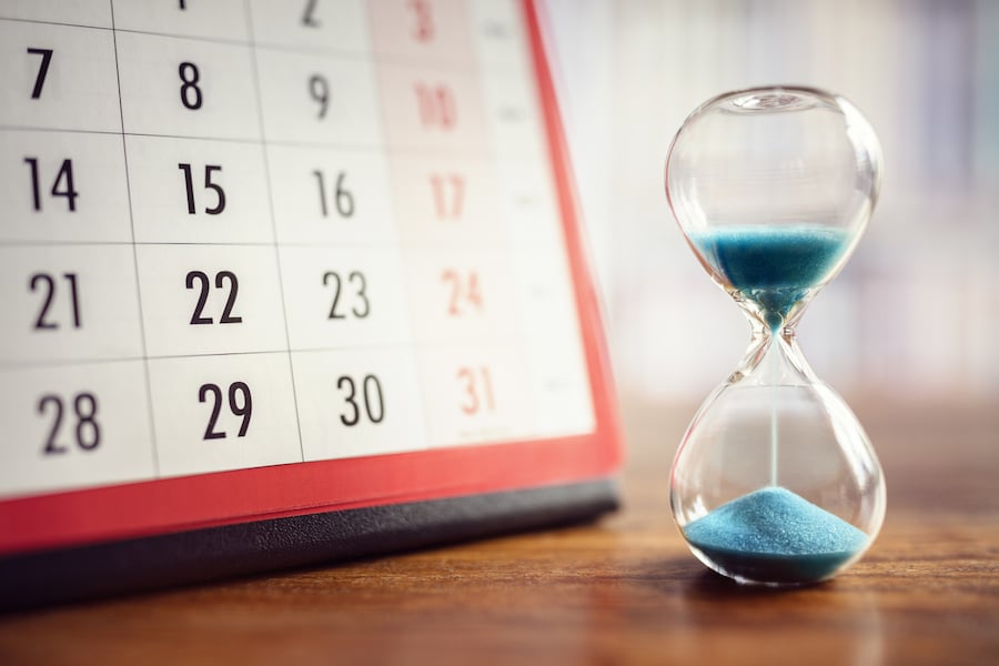 Hour glass and calendar concept for time slipping away for important deadline