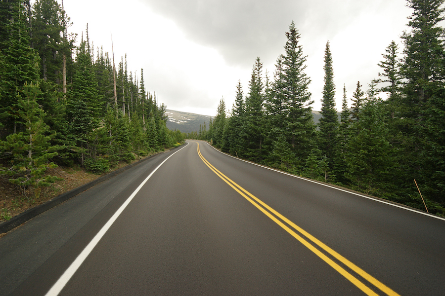 "A perfectly smooth, newly repaved road runs winds through the forest and mountains of Rocky Mountain National Park (Colorado)."