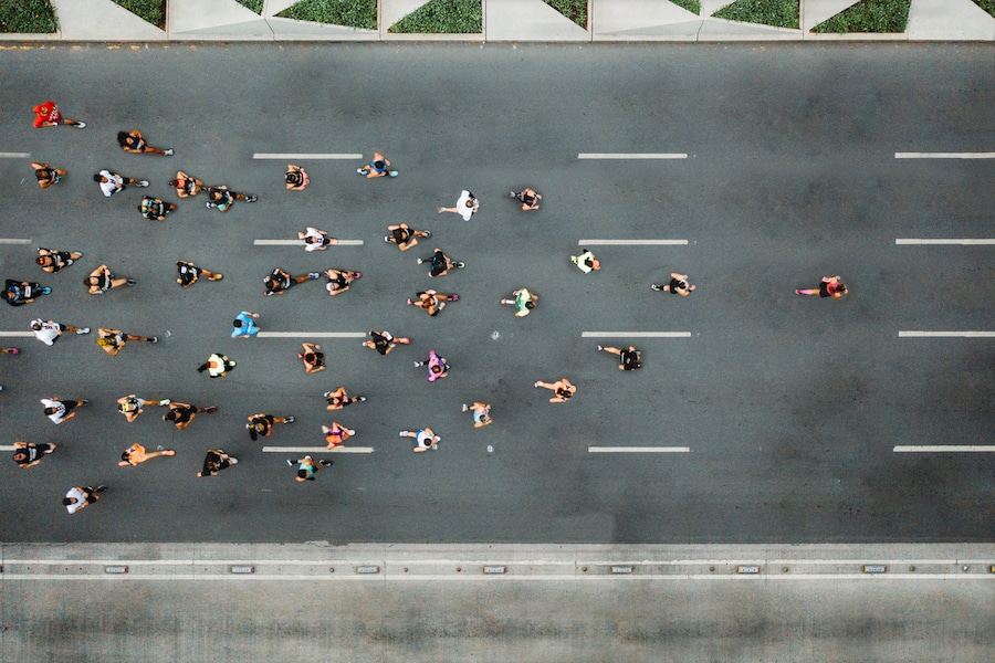 Aerial view of marathon city runners. One person leading marathon.