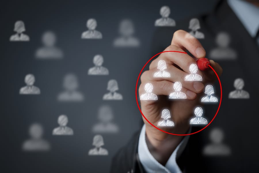 Person drawing a circle around a group of profiles - Targeted Marketing concept